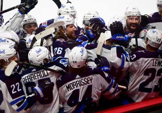 Winnipeg Jets players gather around Nikolaj Ehlers after he scored the game-winning goal in overtime past Ottawa Senators goaltender Matt Murray in Ottawa on Tuesday. THE CANADIAN PRESS/Sean Kilpatrick