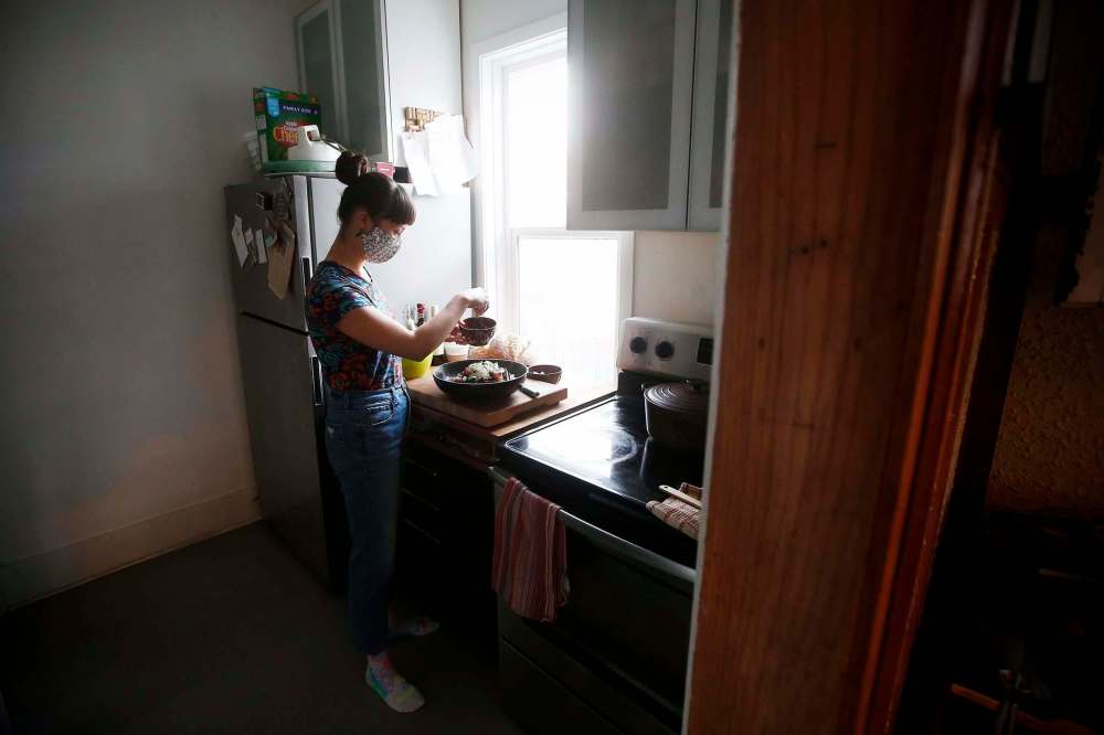 Emily Butcher, who is chef de cuisine at Deer + Almond, prepares a panzanella in her home in Winnipeg. (John Woods / Winnipeg Free Press)