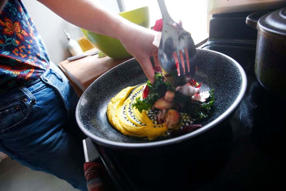 Emily Butcher, who is chef de cuisine at Deer + Almond, prepares a panzanella in her home in Winnipeg. (John Woods / Winnipeg Free Press)