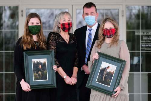 Daniel Crump / Winnipeg Free Press. (LtoR) Julia Hobson, Kim Crichton, Scott Crichton and Susan Crichton. The Crichton family poses for a picture at Thomson in the Park funeral home after the funeral of family member Vincent Crichton. December 12, 2020.