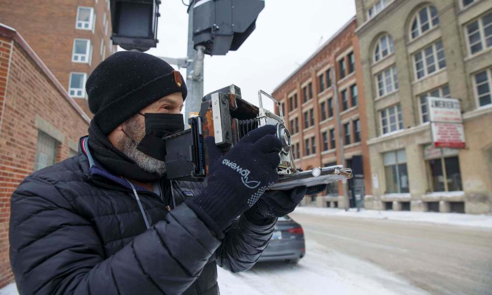 Keith Levit focuses the large-format 4x5 camera he’s used to take photos of street scenes in downtown Winnipeg. (Mike Deal / Winnipeg Free Press)