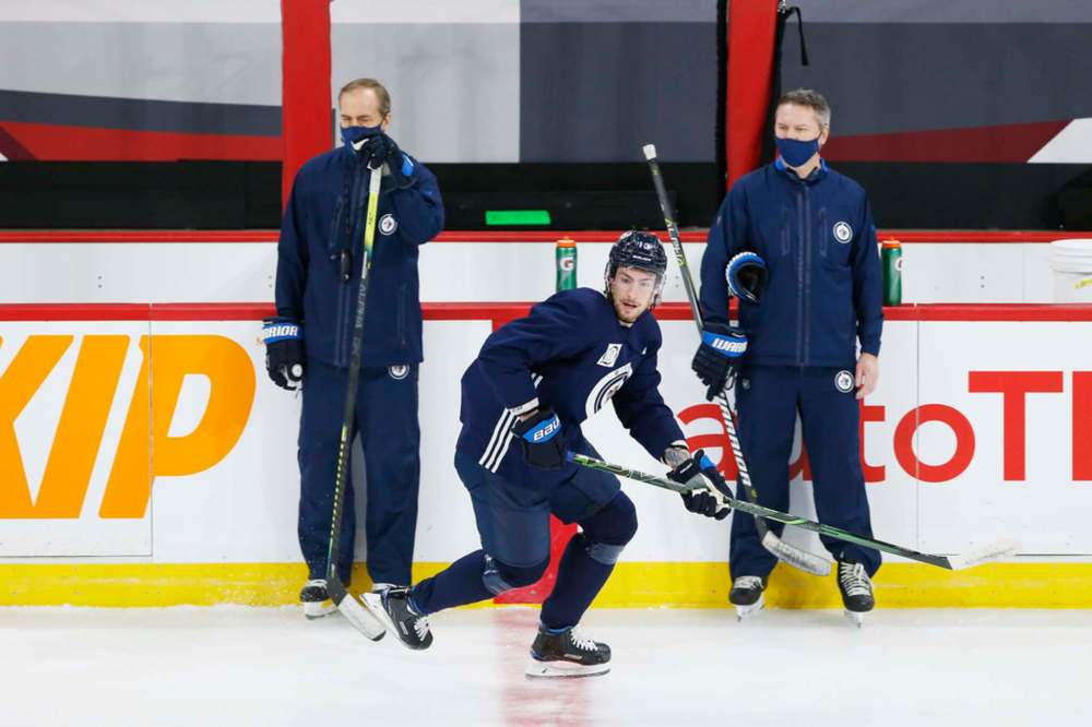 JOHN WOODS / WINNIPEG FREE PRESS
Winnipeg Jets' Pierre-Luc Dubois skates past coaches Paul Maurice and Wade Flaherty at practice in Winnipeg on Sunday.