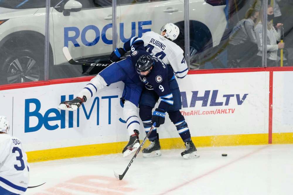 Daniel Crump / Winnipeg Free Press
Manitoba’s Leon Gawanke rubs out Toronto Marlies Kristians Rubins Monday night.