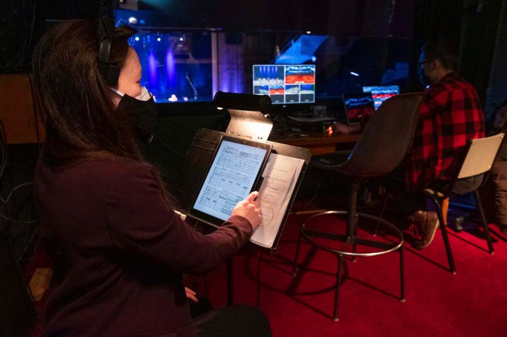 Daniel Crump / Winnipeg Free Press
Woo uses a tablet to follow along with music as she works behind-the-scenes cuing film camera operators for WSO livestream shows.