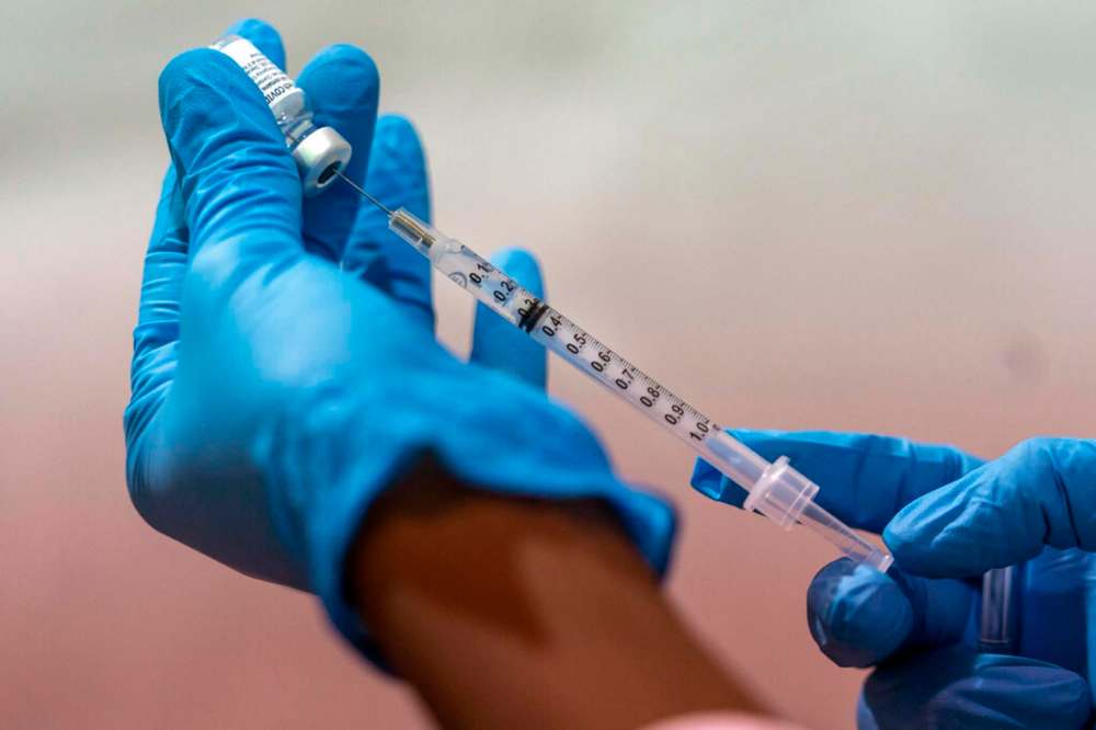A syringe being filled with the Pfizer-BioNTech COVID-19 vaccine. (AP Photo/Mary Altaffer, File)