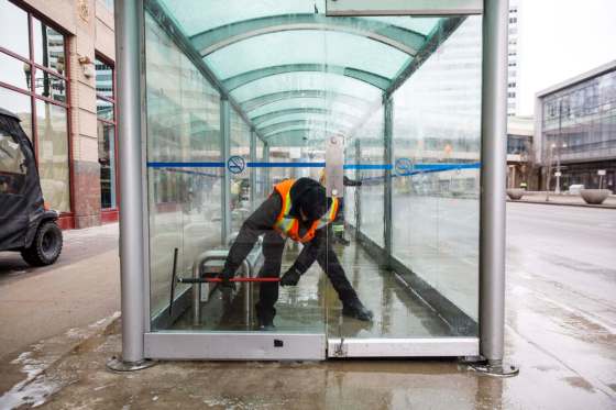 MIKE DEAL / WINNIPEG FREE PRESSThe Enviro Team with the Downtown Winnipeg BIZ cleans the bus shelter on Portage Avenue outside of the Portage Place Shopping Centre Tuesday afternoon. They were washing away blood on the benches where a 19-year-old male and a 50-year-old female were seriously assaulted Monday evening.