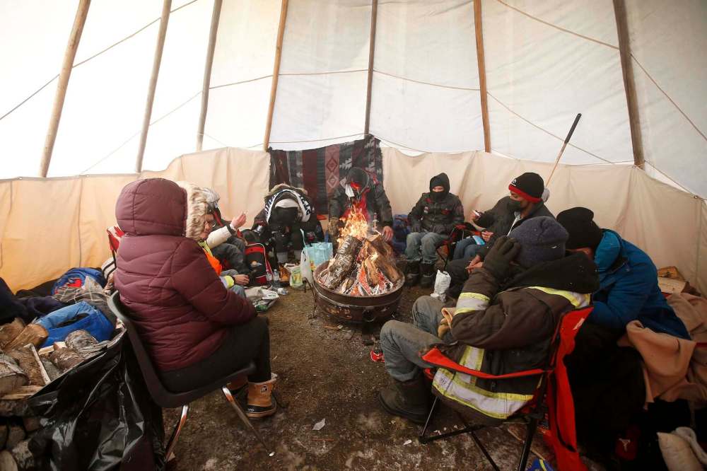 JOHN WOODS / WINNIPEG FREE PRESSPeople warm up in a teepee at the Anishinative camp at Thunderbird House in Winnipeg Sunday, February 14, 2021.
Reporter: Sellar