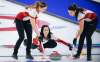 Team Canada skip Kerri Einarson, centre, makes a shot as lead Briane Meilleur, right, and second Shannon Birchard sweep at the Scotties Tournament of Hearts in Calgary. THE CANADIAN PRESS/Jeff McIntosh