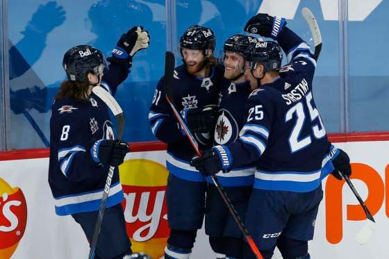 Winnipeg Jets' Sami Niku (8), Kyle Connor (81), Nikolaj Ehlers (27) and Paul Stastny (25)celebrate Connors' goal against Montreal Canadiens goaltender Carey Price (31) during second period NHL action in Winnipeg on Thursday, February 25, 2021. THE CANADIAN PRESS/John Woods