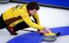 Team Manitoba skip Jason Gunnlaugson makes a shot as he plays Team New Brunswick at the Brier in Calgary, Alta., Tuesday. THE CANADIAN PRESS/Jeff McIntosh