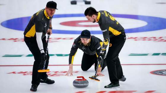 Jeff McIntosh / The Canadian PressTeam Wild Card 1 skip Mike McEwen watches his rock as lead Colin Hodgson (right) and second Derek Samagalski prepare to sweep against Team Alberta.