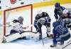 Nathan Denette / The Canadian Press
Jets goaltender Connor Hellebuyck makes a save against Maple Leafs centre Alexander Kerfoot as defenceman Josh Morrissey looks for the loose puck Tuesday night in Toronto.