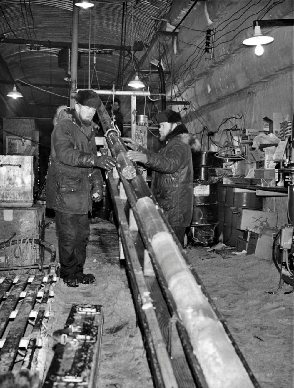 Engineers pull up a section of ice core at Camp Century in the 1960s. (U.S. Army Corps of Engineers files)