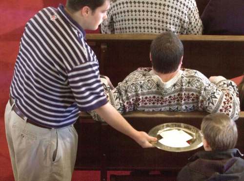 Parishoners passed on passing the collection plate last year. According to a recent survey, giving to churches and Christian ministries in Canada dropped by $1.5 billion. (AP Photo Files/Mark Humphrey)
