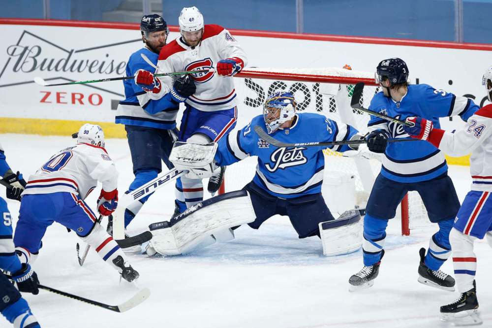 Winnipeg Jets goaltender Connor Hellebuyck saves a shot from Montreal Canadiens' Tomas Tatar during the first period in Winnipeg on Wednesday. THE CANADIAN PRESS/John Woods