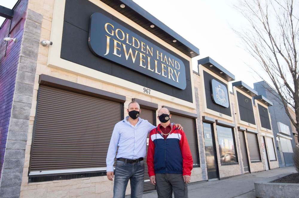 Szurlej (left) and his dad, Chester, in front of the new Golden Hand Jewellery building. The new location offers more space for staff, stock — and their office dogs.  (Mike Sudoma / Winnipeg Free Press)