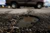 JOHN WOODS / WINNIPEG FREE PRESS FILES
Cars pass a pothole on Henderson in Winnipeg. CAA Manitoba is hoping to draw attention to the province's worst-kept roadways by giving road users a chance to highlight problem areas.