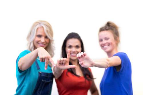 Supplied
From left, Joanna Hawkins, Shannon Guile and Anna-Laure Koop spell out the letters for Plé in ASL.