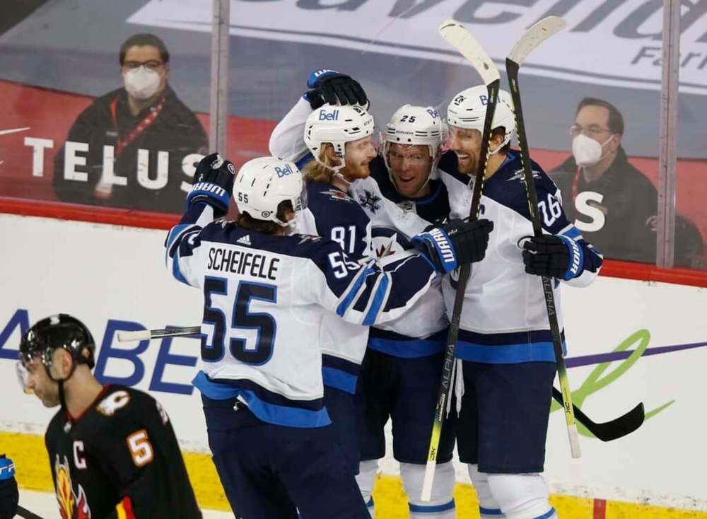 Winnipeg Jets' Blake Wheeler celebrates his goal with teammates Mark Scheifele (55), Kyle Connor (81) and Paul Stastny (25) during the first period in Calgary, Friday. THE CANADIAN PRESS/Todd Korol