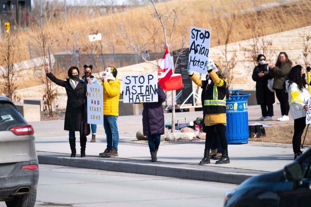 Hundreds of people took part in an anti-Asian hate vehicle rally in front of the Canadian Museum for Human Rights at the Forks in downtown Winnipeg on Saturday. The event was organized by Women of Colour Community Leadership initiative Manitoba and the Manitoba Chinese Family Centre. (Daniel Crump / Winnipeg Free Press)