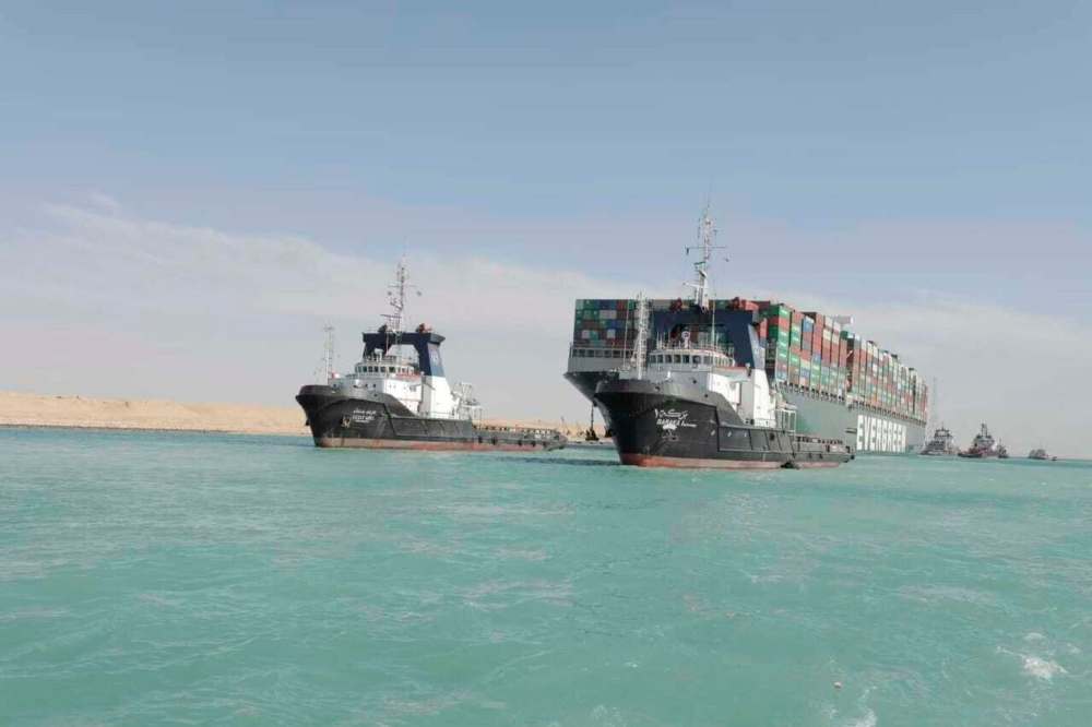 Suez Canal Authority via AP
The Panama-flagged cargo ship Ever Given is accompanied by tugboats as it moves in the Suez Canal on March 29.