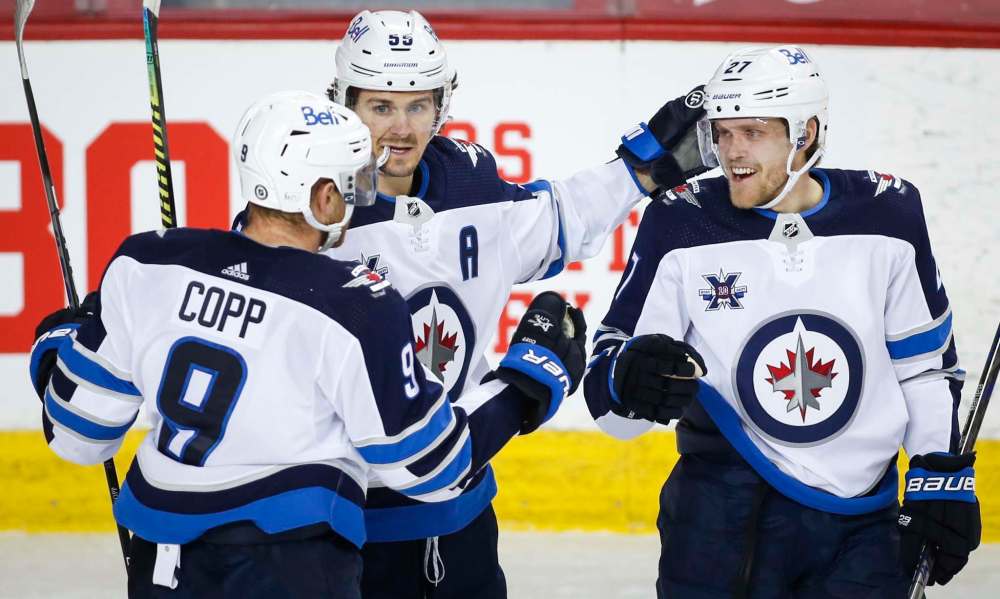 Jeff McIntosh / The Canadian Press
Andrew Copp, left, celebrates his goal with teammates Mark Scheifele, centre, and Nikolaj Ehlers.