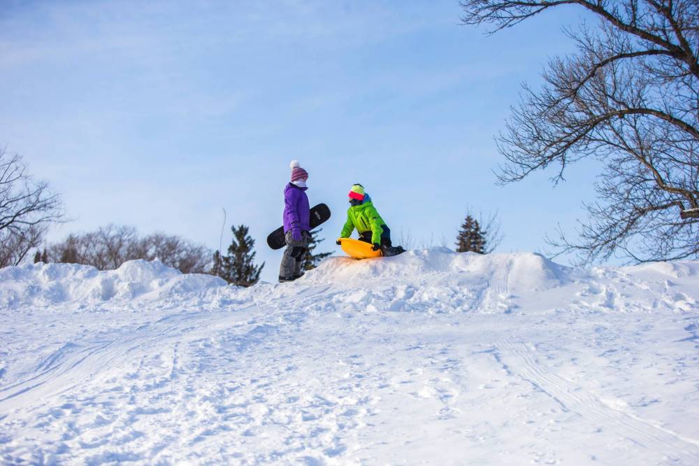Isla (nine, left) and Grace (11) Hill sled in Churchill Drive Park last week. Compared to the last few years of late snow and little precipitation, we’re living in a veritable winter wonderland this year. (Mikaela MacKenzie / Winnipeg Free Press)