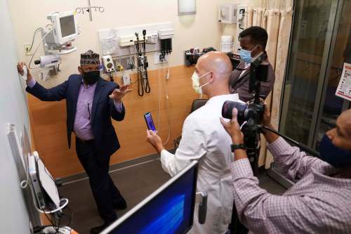 Anthony Souffle / Minneapolis Star Tribune
Imam Sharif Mohamed consults with Dr. Thomas Wyatt, who uses a GPS compass app to find the exact location to place a qibla sticker in the Emergency Department at the Hennepin County Medical Center in downtown Minneapolis.