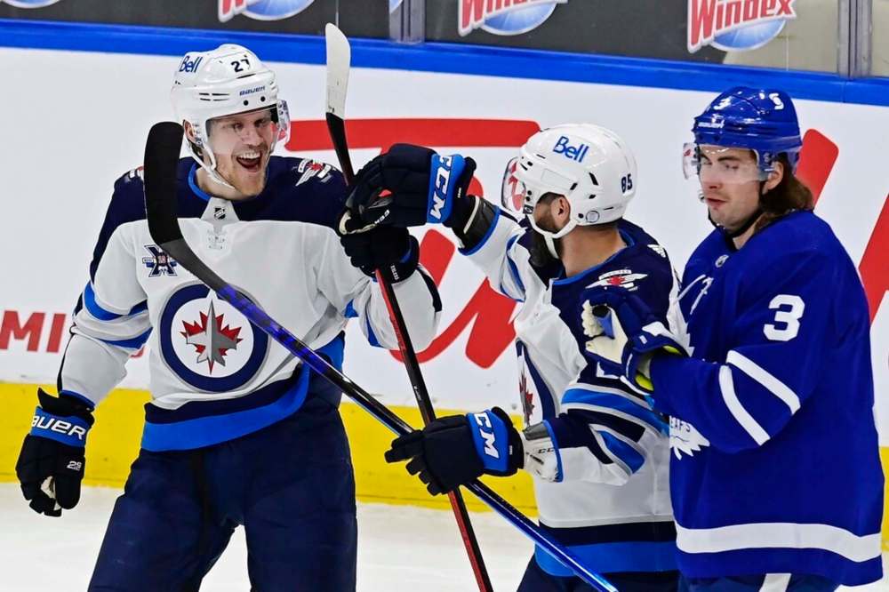 Winnipeg Jets' Nikolaj Ehlers celebrates his goal against the Toronto Maple Leafs with teammate Mathieu Perreault during the first period in Toronto on Thursday. THE CANADIAN PRESS/Frank Gunn