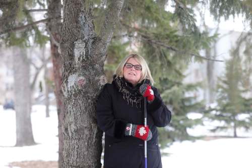 RUTH BONNEVILLE / WINNIPEG FREE PRESS
Doris Koop, executive director of the Vision Impaired Resource Network, enjoys the smell of pine trees and the natural sounds in Vimy Ridge Park during her lunch hour recently. Research in a growing scientific field called ecotherapy has shown a strong correlation between time spent in nature and reduced anxiety and depression.