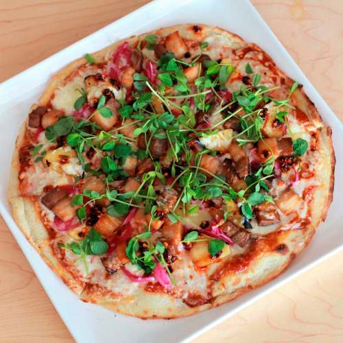 Supplied
Rae&rsquo;s Bistro is offering Get In My Belly, an Asian-inspired pie with braised pork belly, barbecue sauce, pea shoots, charred pineapple and pickled red onion.