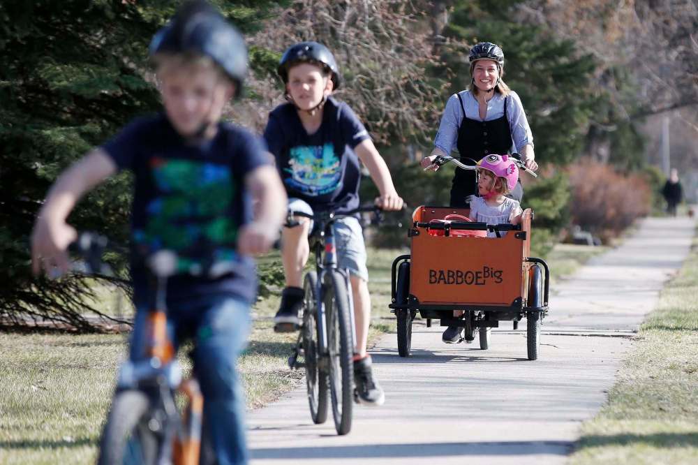Meghan Cameron and her kids (from left) Magnus, Griffin and Beatrix have been trying to live a greener lifestyle during the last few years. (John Woods / Winnipeg Free Press)