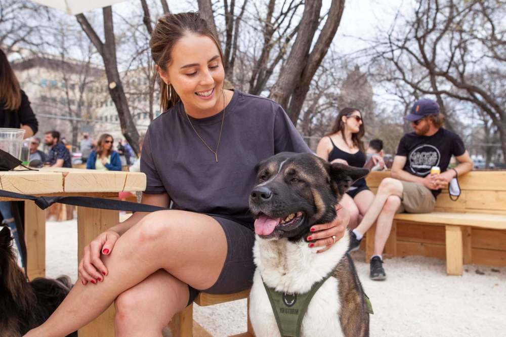 Ashley Hansen and Titus, an American inu, take in the atmosphere at The Beer Can. (Daniel Crump / Winnipeg Free Press)