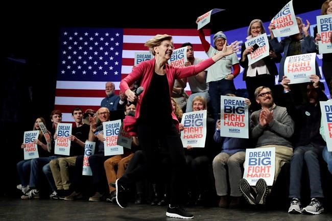 Sen. Elizabeth Warren, D-Mass., runs on stage as she greets a supporter, not shown, at the start of a campaign stop, in Keene, N.H., Tuesday, Feb. 4, 2020. (AP Photo/Steven Senne)