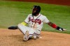 Atlanta Braves' Marcell Ozuna watches after getting called out at home after leaving third early during the third inning in Game 5 of a baseball National League Championship Series against the Los Angeles Dodgers Friday, Oct. 16, 2020, in Arlington, Texas. (AP Photo/Tony Gutierrez)