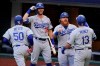 Los Angeles Dodgers' Max Muncy (13) celebrates his grand slam home run during the first inning in Game 3 of a baseball National League Championship Series against the Atlanta Braves Wednesday, Oct. 14, 2020, in Arlington, Texas. (AP Photo/Tony Gutierrez)