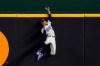 Los Angeles Dodgers right fielder Mookie Betts robs Atlanta Braves' Freddie Freeman of a home run during the fifth inning in Game 7 of a baseball National League Championship Series Sunday, Oct. 18, 2020, in Arlington, Texas. (AP Photo/Tony Gutierrez)
