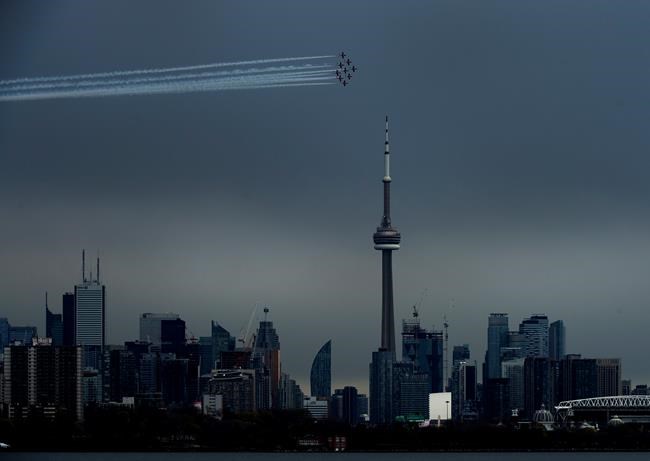 The Canadian Snowbirds circle the CN Tower as part of Operation Inspiration during the COVID-19 pandemic in Toronto on Sunday, May 10, 2020. THE CANADIAN PRESS/Nathan Denette