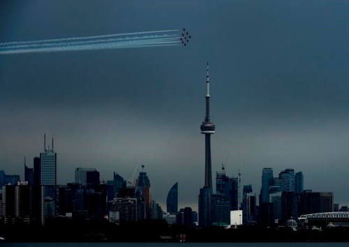 The Canadian Snowbirds circle the CN Tower as part of Operation Inspiration during the COVID-19 pandemic in Toronto on Sunday, May 10, 2020. THE CANADIAN PRESS/Nathan Denette