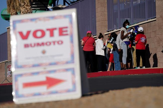 People wait in line to vote at a polling place on Election Day, Tuesday, Nov. 3, 2020, in Las Vegas. (AP Photo/John Locher)