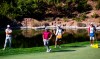 Matthew Wolff, left, and Tyrrell Hatton, second from left, watch as Jon Rahm (not shown) putts on the fourth green during the first round of the CJ Cup golf tournament at Shadow Creek Golf Course, Thursday, Oct. 15, 2020, in North Las Vegas. (Chase Stevens/Las Vegas Review-Journal via AP)