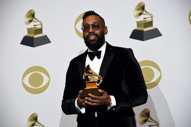 FILE - In this Sunday, Jan. 26, 2020 file photo, PJ Morton poses in the press room with the award for best R&B song for