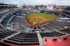 FILE - The New York Yankees and the Washington Nationals stand on the field before their opening day baseball game with no fans in the seats at Nationals Park in Washington, in this Thursday, July 23, 2020, file photo. Sports events held amid the coronavirus pandemic have become a whole different sort of spectacle when it comes to spectators. (AP Photo/Alex Brandon, File)