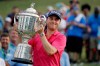 FILE - In this Aug. 13, 2017, file photo, Justin Thomas poses with the Wanamaker Trophy after winning the PGA Championship golf tournament at the Quail Hollow Club in Charlotte, N.C. Justin Thomas can put down the driver and grab a controller: The former PGA Championship winner made the cover of the 