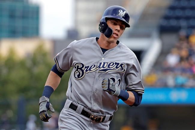 FILE - In this Monday, Aug. 5, 2019 file photo, Milwaukee Brewers' Christian Yelich rounds third after hitting a solo home run off Pittsburgh Pirates starting pitcher Dario Agrazal during the first inning of a baseball game in Pittsburgh. The Milwaukee Brewers have a lot of work to do in spring training. Having Christian Yelich sure helps. Yelich was working on a strong case for his second straight NL MVP award last year when he broke his right kneecap in September, sidelining the All-Star slugger for the rest of the season. (AP Photo/Gene J. Puskar, File)