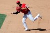 FILE - Then-Los Angeles Angels shortstop Andrelton Simmons throws to first to get Texas Rangers' Rougned Odor out on a ground ball during the sixth inning of a baseball game in Anaheim, Calif., in this Sunday, Sept. 20, 2020, file photo. After a travel documentation delay in his native country Curaçao, new shortstop Andrelton Simmons has finally settled in at spring training with the Minnesota Twins, who are getting a big boost to the left side of their infield from the 31-year-old glove whiz. (AP Photo/Alex Gallardo, File)