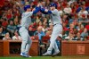 FILE - In this Sept. 28, 2019, file photo, Chicago Cubs' Nico Hoerner, left, celebrates with teammate Ian Happ after Happ hit a two-run home run during the third inning of a baseball game against the St. Louis Cardinals in St. Louis. When the coronavirus pandemic stopped spring training last month, Ian Happ offered Nico Hoerner, Zack Short and Dakota Mekkes a place to stay if they wanted to remain in Arizona. That's how “The Compound” was born. (AP Photo/Scott Kane, File)