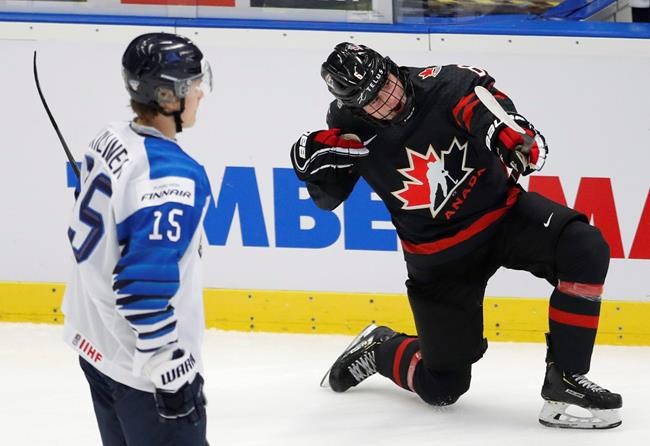 FILE - In this Saturday, Jan. 4, 2020, file photo, Finland's Lenni Killinen, left, skates past as Canada's Jamie Drysdale, right, celebrates after scoring his sides third goal during the U20 Ice Hockey Worlds semifinal match in Ostrava, Czech Republic. Drysdale is a prospect in the upcoming NHL Draft. (AP Photo/Petr David Josek, File)