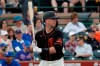 FILE - In this March 10, 2020 file photo, San Francisco Giants' Buster Posey hits against the Chicago Cubs during the first inning of a spring training baseball game in Scottsdale, Ariz. Posey, David Price, Marcus Stroman and more than a dozen other players who opted out of the pandemic-shortened 2020 season get back to work this week. They not only will have to deal with rust but the demands of MLB’s coronavirus safety protocols. (AP Photo/Matt York, File)