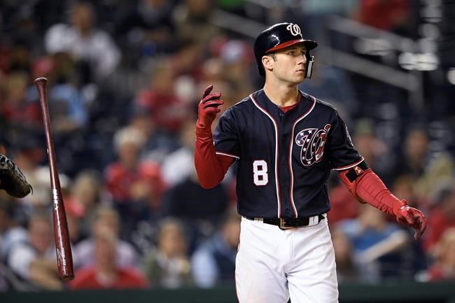 FILE - In this May 1, 2019, file photo, Washington Nationals' Carter Kieboom tosses his bat after he struck out swinging during the eighth inning of the team's baseball game against the St. Louis Cardinals in Washington. If, as he hopes, and the Washington Nationals hope, Carter Kieboom does, indeed, earn a job this spring as the reigning World Series champions' new starting third baseman, he'll do so with the help of years' worth of ideas typed into his cellphone's Notes app. (AP Photo/Nick Wass, File)